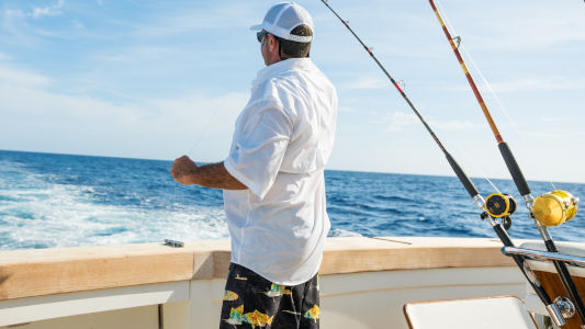 man offshore fishing on a boat