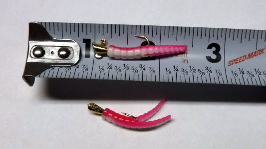 pink and white trout magnet lure on tape measure
